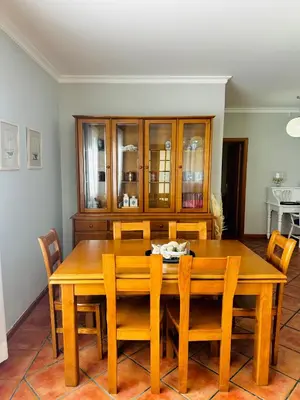 a dining room with a wooden table and chairs at Quinta do Ribeiro Salgado's Beach House in Porto Santo