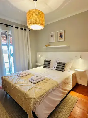 a bedroom with a large bed with towels on it at Quinta do Ribeiro Salgado's Beach House in Porto Santo