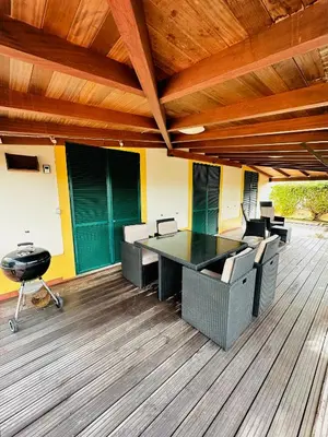 an office with a table and chairs on a wooden floor at Quinta do Ribeiro Salgado's Beach House in Porto Santo
