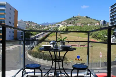 a table and chairs on a balcony with a view at Angel's Apartment in Funchal