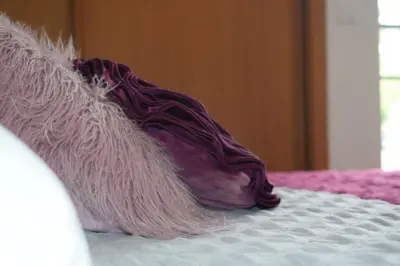 a blanket laying on top of a bed at Angel's Apartment in Funchal