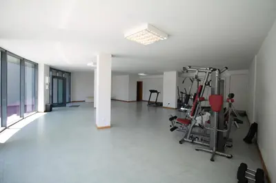 an empty room with a gym with exercise equipment at Angel's Apartment in Funchal