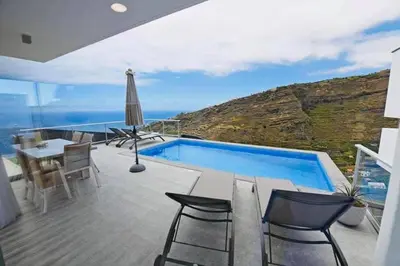 a house with a swimming pool and a table and chairs at Villa Golden Charm in Tábua