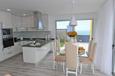 a kitchen and dining room with a table and chairs at Villa Golden Charm in Tábua