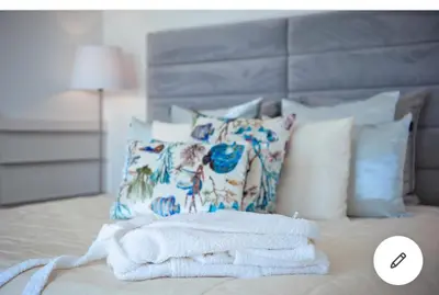 a pile of towels sitting on top of a bed at Villa Atlantic Charm in Venda do Atalhinho