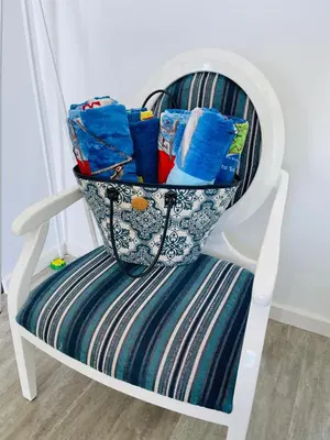 a white rocking chair with bags on it at Villa Atlantic Charm in Venda do Atalhinho