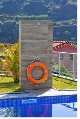 an orange life raft sitting next to a pool at Villa Atlantic Charm in Venda do Atalhinho