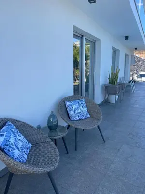 two wicker chairs and a table on a patio at Villa Atlantic Charm in Venda do Atalhinho