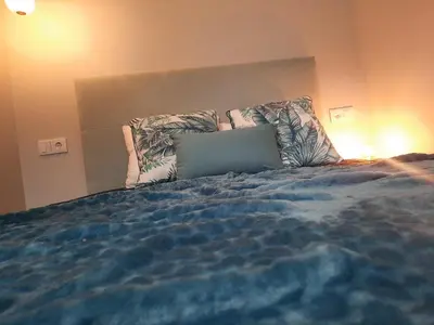 a bedroom with a bed with a laptop on it at Marques studio in Porto da Cruz