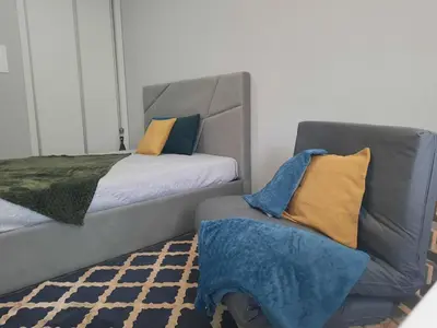 a bedroom with a bed and a couch with pillows at Marques studio in Porto da Cruz