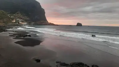 a beach with the ocean and a mountain at Marques studio in Porto da Cruz