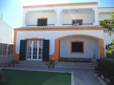 a house with a courtyard in front of it at Casa Machado in Sagres