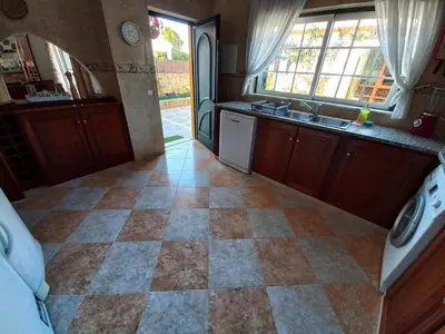 a bedroom with a bed and a checkered floor at Casa Machado in Sagres