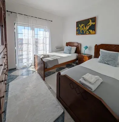 a bedroom with a bed and a checkered floor at Casa Machado in Sagres