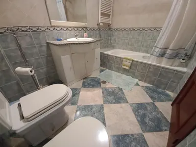 a bathroom with a toilet and a sink and a tub at Casa Machado in Sagres