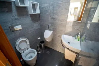 a bathroom with a white toilet and a sink at Beach Sunset Villa 100m from Ocean & Beach in Paul do Mar