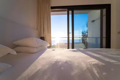 a bedroom with a bed with a view of the ocean at Beach Sunset Villa 100m from Ocean & Beach in Paul do Mar