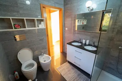 a bathroom with a toilet and a sink and a shower at Beach Sunset Villa 100m from Ocean & Beach in Paul do Mar