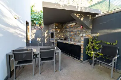 a kitchen with a table and chairs and a counter at Beach Sunset Villa 100m from Ocean & Beach in Paul do Mar