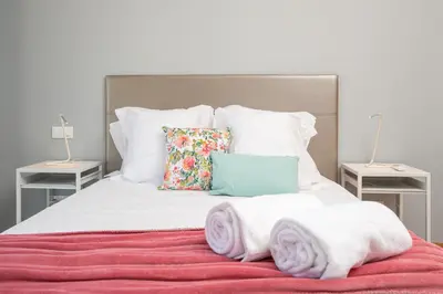 a bedroom with a bed with towels on it at Luxurious Apartment Funchal - Casa Valentina - Rent2U, Lda in Funchal