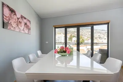 a white dining room with a white table and white chairs at Luxurious Apartment Funchal - Casa Valentina - Rent2U, Lda in Funchal