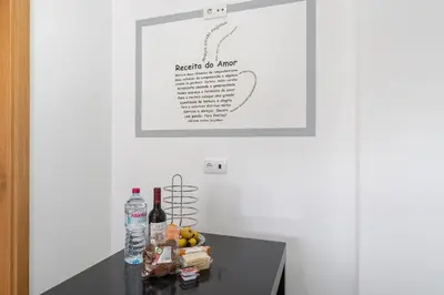 a table with bottles of wine and fruit on it at Luxurious Apartment Funchal - Casa Valentina - Rent2U, Lda in Funchal