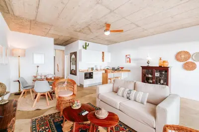 a living room with a couch and a table at CASA 61 by Stay Madeira Island in Ponta do Sol