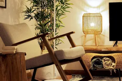 a living room with a chair and a plant at Casa da Julia e Alice, a Home in Madeira in Funchal