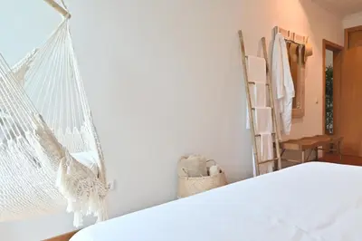a bedroom with a bed and a hammock at Casa da Julia e Alice, a Home in Madeira in Funchal