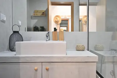 a bathroom with a white sink and a mirror at Casa da Julia e Alice, a Home in Madeira in Funchal