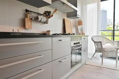 a kitchen with white cabinets and a stove at Casa da Julia e Alice, a Home in Madeira in Funchal
