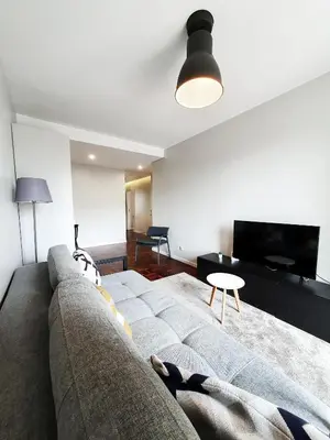 a person laying on a couch in a living room at Santa Luzia's Pearl II E - One Bedroom Apartment in Funchal