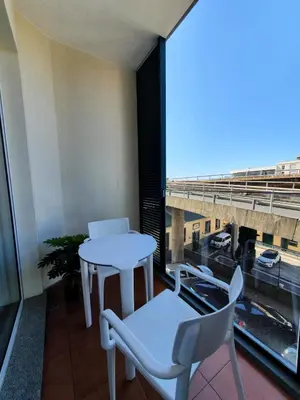 a room with a table and chairs and a window at Santa Luzia's Pearl II E - One Bedroom Apartment in Funchal