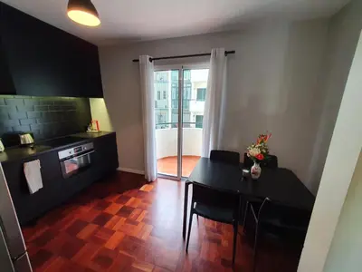 a kitchen with a table and a dining room at Santa Luzia's Pearl II E - One Bedroom Apartment in Funchal
