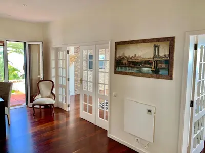 a living room with a painting on the wall at Villa Isabela - Car Rental for Free in Caniço