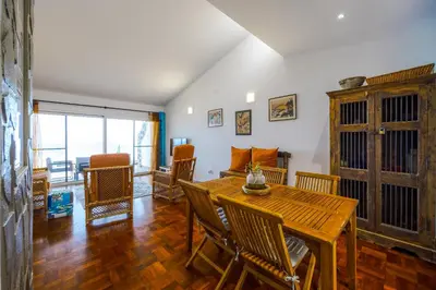 a dining room with a wooden table and chairs at Casa Maravilha III in Caniço