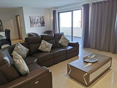 a living room with a couch and a coffee table at Sun Island Apartments in Funchal