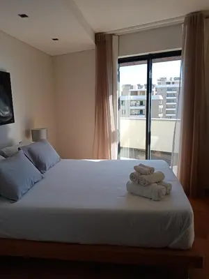 a bedroom with a bed with two towels on it at Sun Island Apartments in Funchal