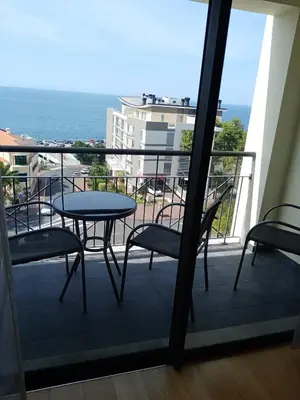 a balcony with a table and chairs and the ocean at Sun Island Apartments in Funchal