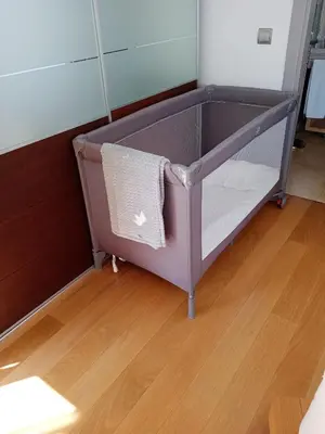 a crib in a room with a wooden floor at Sun Island Apartments in Funchal