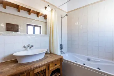 a bathroom with a white tub and a sink and a bath tub at Townhouse Sagres in Sagres