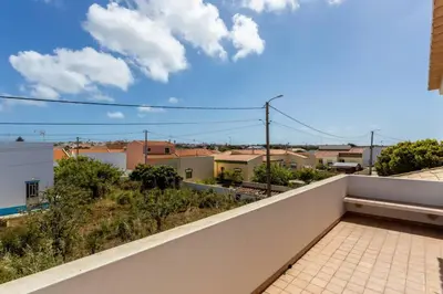 a balcony with a view of a city at Townhouse Sagres in Sagres