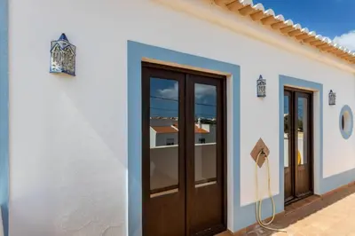 a white building with two doors and a window at Townhouse Sagres in Sagres
