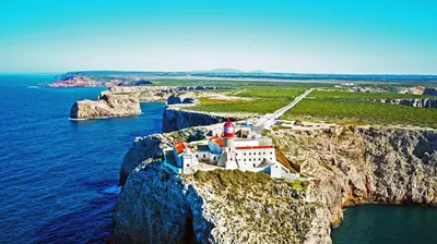 an island with a lighthouse on a cliff at Townhouse Sagres in Sagres