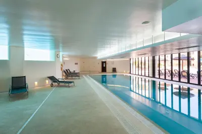 a large swimming pool in a building with a pool at Seaview apartment - Estrela da Luz**** in Luz