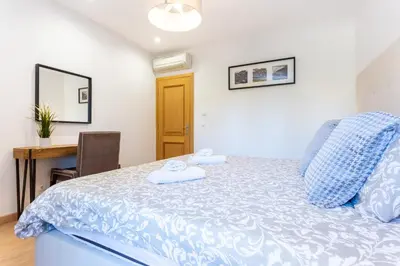 a bedroom with a bed and a desk and a table at Seaview apartment - Estrela da Luz**** in Luz