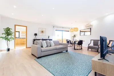 a living room with a couch and a tv at Seaview apartment - Estrela da Luz**** in Luz