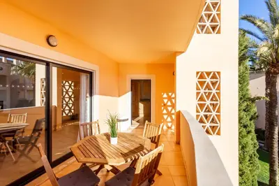 a patio with a table and chairs on a balcony at Seaview apartment - Estrela da Luz**** in Luz