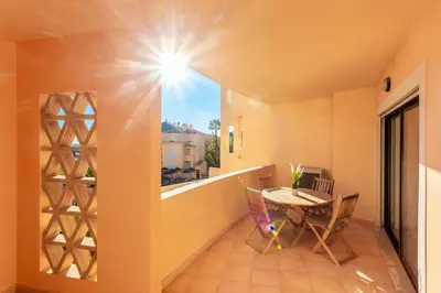 a balcony with a table and chairs and a window at Seaview apartment - Estrela da Luz**** in Luz