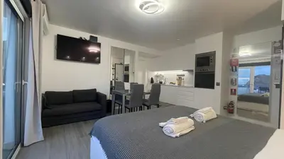 a bedroom with a bed and a kitchen and a living room at Sea and Sun 4 You - Horizonte Azul in Porto Moniz